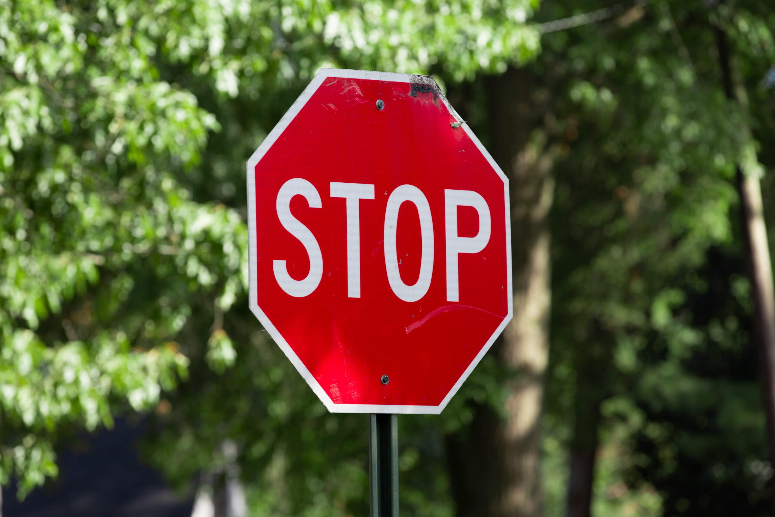 Taxpayer holding stop sign in front of IRS collection notices representing Currently Not Collectible status halting IRS enforcement